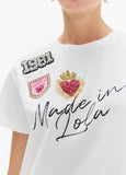lf2615044-Crew-neck t-shirt with side slits, ''made in lola'' graphic with patches-White