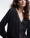 Blouse with eyelets