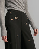 Trousers with eyelets detail